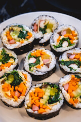 Handmade korean kimbap rolls arranged on white dish