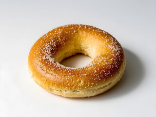 Sugar sprinkle bagel with a twisted shape, freshly baked, isolated on white background