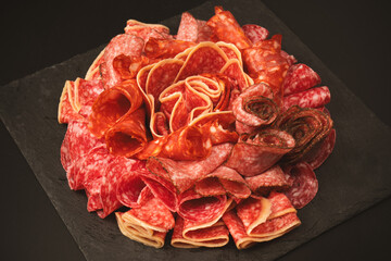 Different kinds of meat cuts on a board.