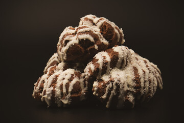 Profiteroles with coconut cream on a black background.