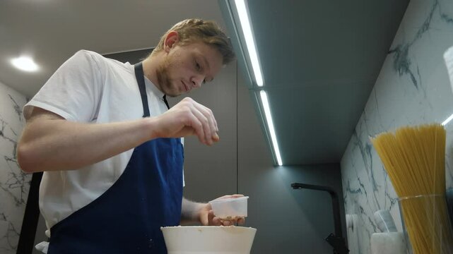 In a modern kitchen, an experienced chef adds salt to ingredients, demonstrating culinary talent, creating exquisite dishes that delight gourmets and elevate each dish, making every meal unforgettable