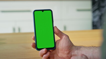 Finger touching mockup cellphone touchscreen turning application at home closeup