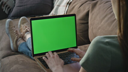 Freelancer browsing mockup laptop application at sofa closeup. Unknown woman