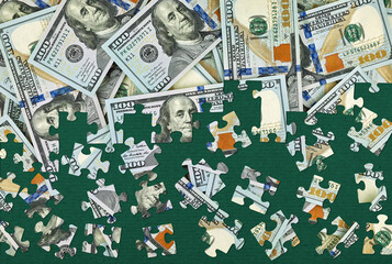 Scattered puzzle pieces made of 100 US dollar bills on a green background.