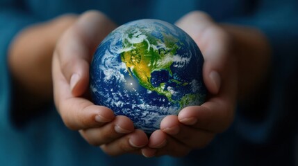 A person is holding a globe in their hands