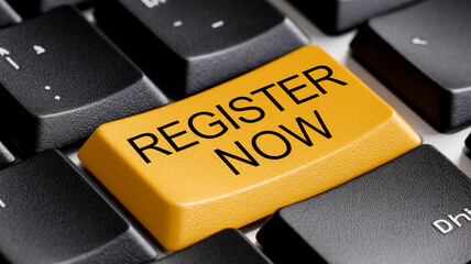 Close-up of yellow keyboard key with "Register Now" text, set against black keys, suggesting online registration or signup process