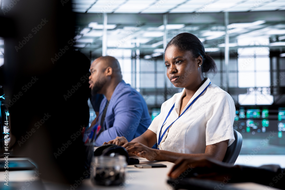 Poster african american admin next to colleagues doing yearly checkup to prolong data center electronics li