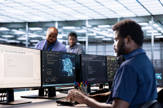 Server farm IT specialist using AI systems to input data faster during complex computational tasks. Software developer in data center using artificial intelligence parallel processing tech
