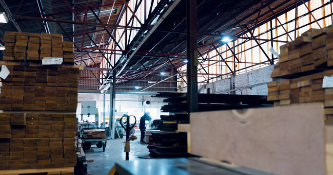 Logistics, empty and stack of wood, warehouse or material for furniture, supply chain or business. Production, shipping and collection of cargo in factory, export or goods for distribution or storage