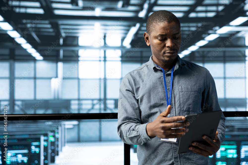 Poster computer scientist in data center uses tablet, verifying compliance of racks. it expert in high tech
