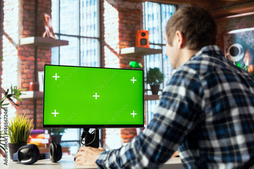 Poster employee seated at home office desk using green screen pc, checking emails displayed on screen, read
