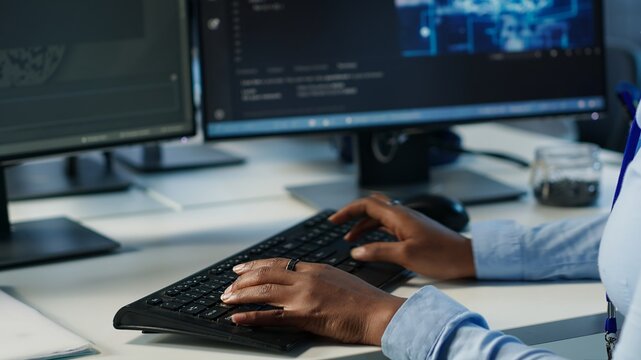 Data center admin using PC to find misconfigurations affecting rackmounts performance. Person checking servers bottlenecks leading to sluggish data transfer rates and malfunctions, camera A close up