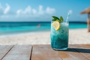 Obraz premium Blue cocktail with lemon and mint on a wooden table at the beach for summer vacation, travel, and relaxation use cases.