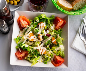 Fresh Caesar salad with chicken breast, lettuce, sauce and cheese