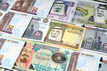 Saudi Arabia riyals SAR cash money bills banknotes and Pile of Egypt money hundreds of Pounds...