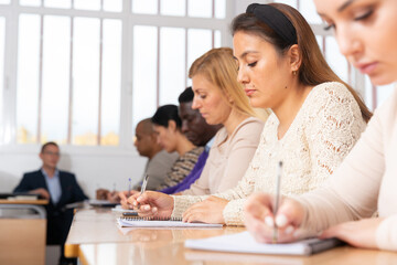 Students listening task for exam in the classroom