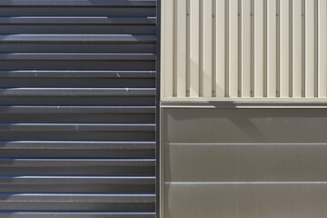 Three different types of siding. Gray, Tan, and brown sheet metal.