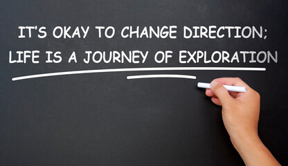 It is okay to change direction, life is a journey of exploration text written on black board. Inspirational and motivational concept.