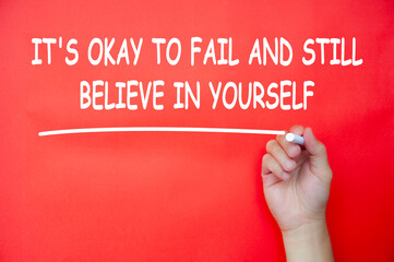 It is okay to fail and still believe in yourself text written on red cover background....
