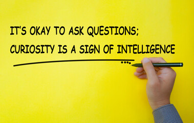 It is okay to ask questions, curiosity is a sign of intelligence text written on yellow cover...