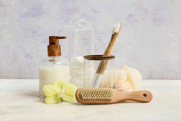 Flower and different bath supplies on light background