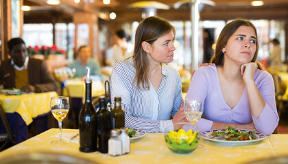 Quarrel of two friends during dinner in a restaurant