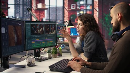 Team of experts editors working in video production industry at agency office, doing color grading and creating a montage on dual monitors. Creative process with multimedia tech tools. Camera A.