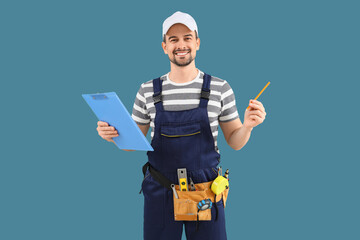Male technician with clipboard on blue background