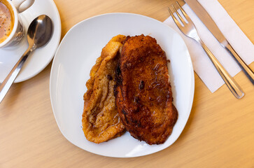 Crispy outside and smooth inside sweet torrijas de leche served on plate. Traditional Spanish treat...