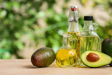 Composition with avocado oil on table outdoors