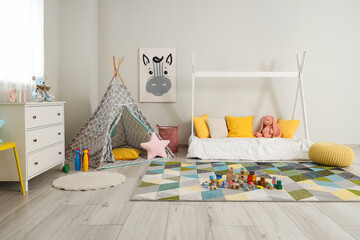 Interior of children's bedroom with bed, dresser and different toys