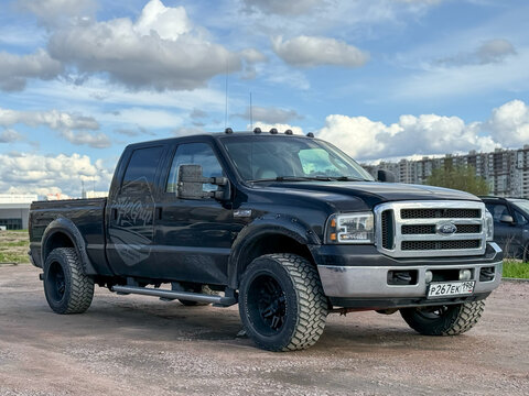 Ford F-350 4x4 black color parked on street. Exterior Ford F-350 SRW Crew Cab XL pickup off-road us vehicle. USA SUV Ford F-350 at the parking. American SUV cars. 