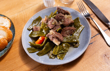 Delicious sliced beef stew served with green beans on platter ..