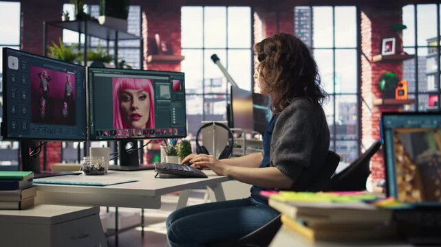 Female graphic designer editing photos on a modern computer setup in agency office, using an enhancement technique. Ideal workspace for a digital design professional, photography. Camera A.