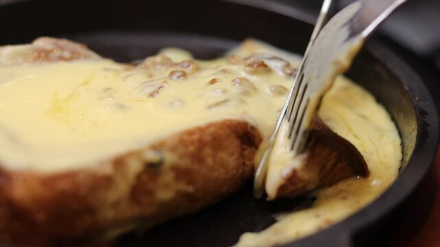 A close-up shot showcasing warm french toast slices generously smothered in melted cheese, oozing with flavor, prepared for a hearty meal. 