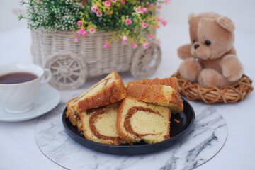 Delicious marble cake slices with tea and teddy bear