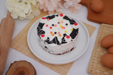 Delicious Birthday Cake with White Frosting and Chocolate Decorations