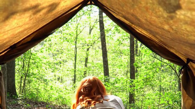 Red Haired Woman Opening Tent Flaps to Reveal Forest Landscape on Sunny Day Camping Adventure into Green Woodland Lush Foliage and Warm Tones