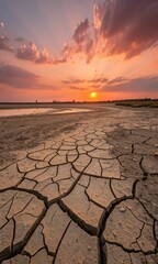 Sunset Over Cracked Earth Landscape.