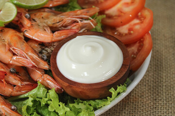 Mayonnaise sauce as a dip for food. Mayonnaise sauce on fried shrimp dish