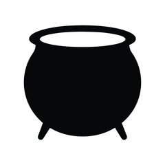 A simple black cauldron standing, prepared for Halloween and magical potions