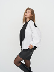 Fashion model showcasing contemporary style in sleek studio setting with striking poses