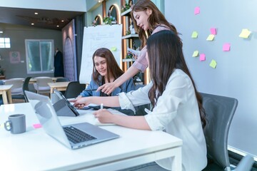 Creative Team of Women Collaborating with Technology in Modern Office.