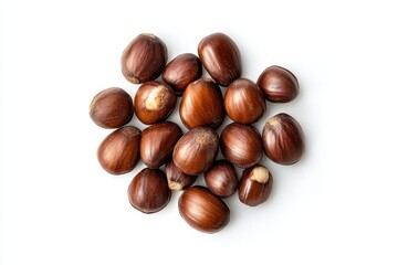 Obraz premium Pile of raw shea nuts with visible kernels on white background