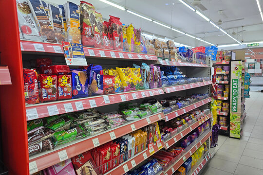 Penang, Malaysia &ndash; May 9, 2025: A well-organized aisle in 7-Eleven displaying a variety of cookies, biscuits, and chocolate snacks, including popular brands like Oreo, Chipsmore, and Milo.