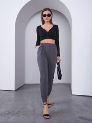 Captivating female model showcasing fashion in a modern studio environment