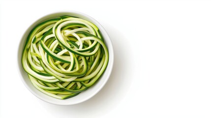 A bowl of spiralized zucchini noodles sits on a white background, showcasing a healthy, fresh, and low-carb pasta alternative.