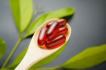 wooden spoon with soft gels, Fish oil capsules, omega 3, omega 9, vitamin D, vitamin E