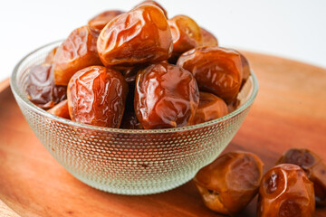 Dates fruit sukari or kurma sukari, in bowl isolated on white background