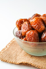Dates fruit sukari or kurma sukari, in bowl isolated on white background